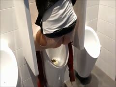 A scat girl was caught urinating in a public men's toilet.